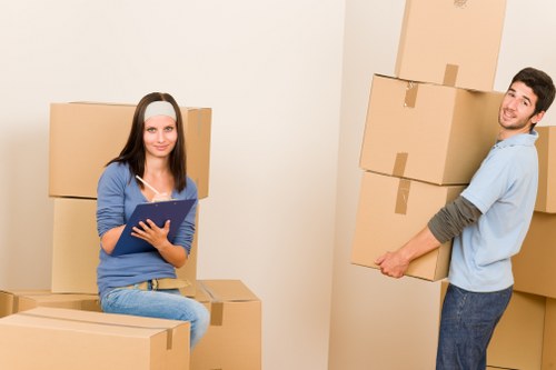 Person placing packed boxes into a secure storage unit